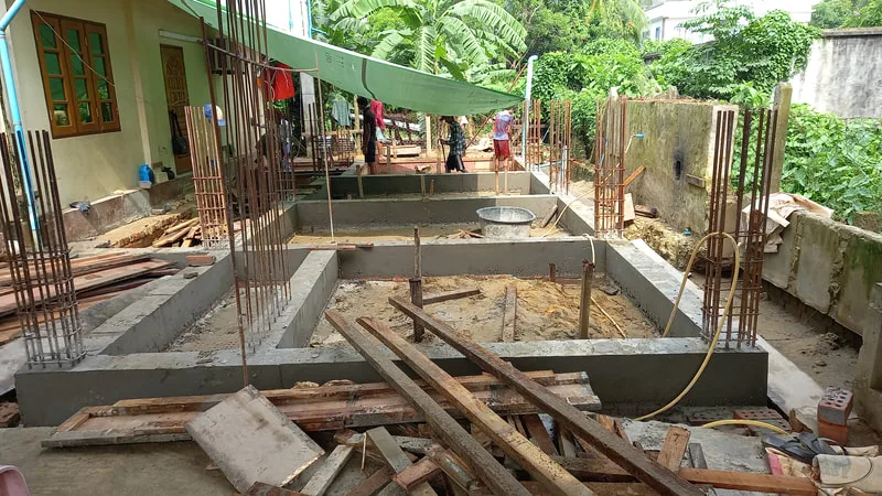 Reinforced concrete foundations beside a building