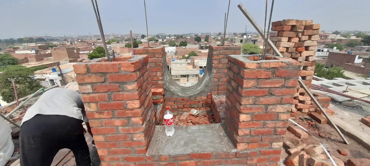 Brickwork around a decorative rooftop arch