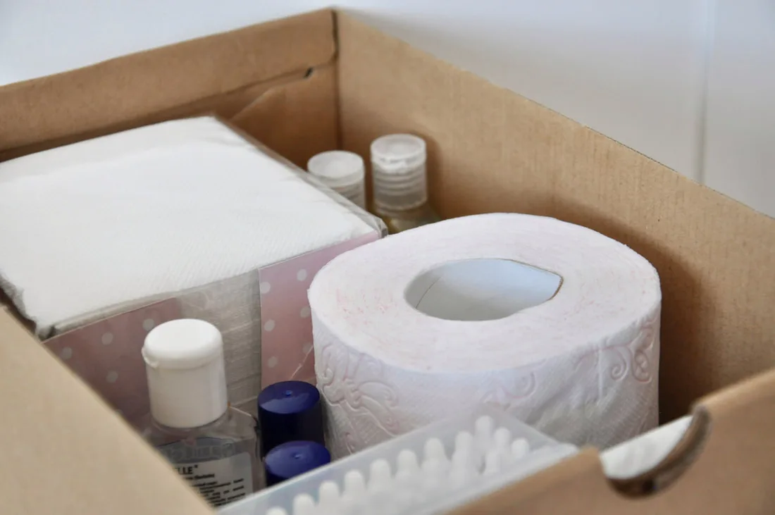 Box containing toiletries and household supplies