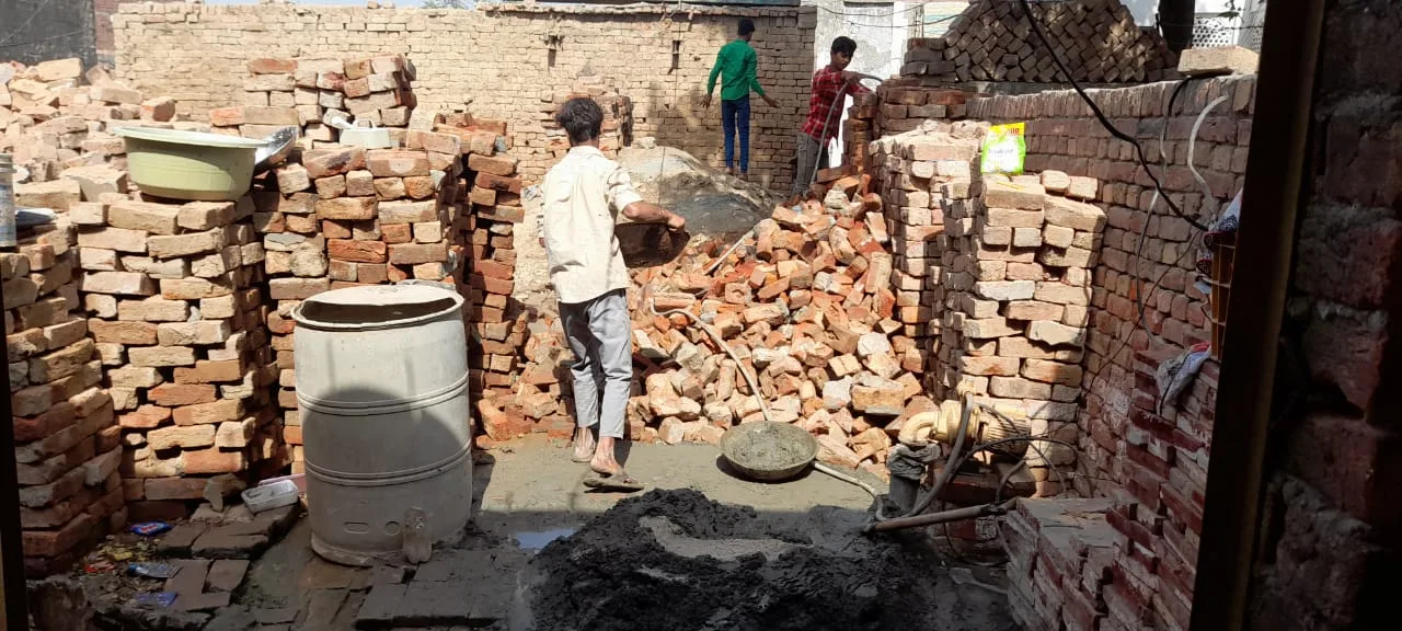 Worker standing among bricks and rubble