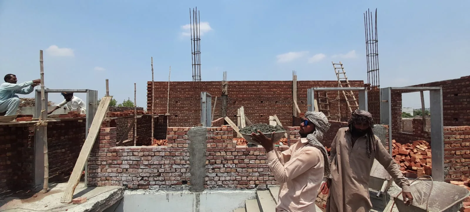 Workers building brick walls at Pakistan Bible College