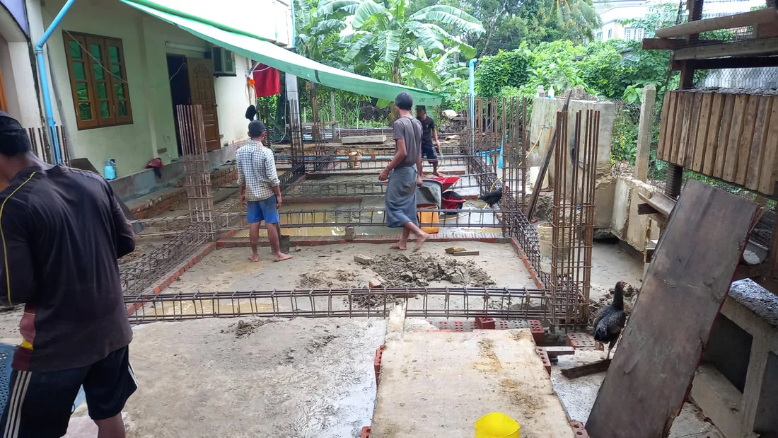 Workers laying reinforcement for a concrete floor