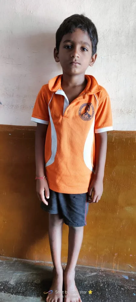 Child standing beside a wall