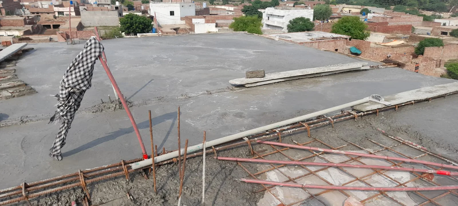 Concrete being poured across a roof slab
