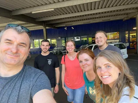 Group standing together inside a warehouse