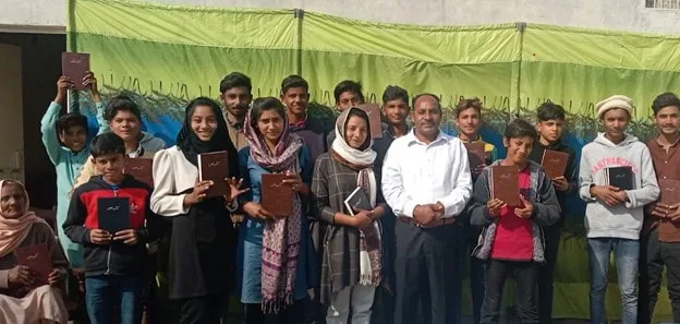Group holding books at a Myanmar orphanage