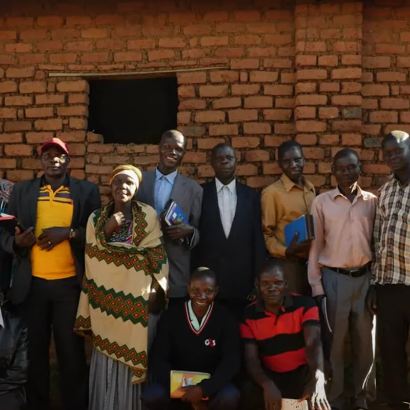 Group outside a brick building