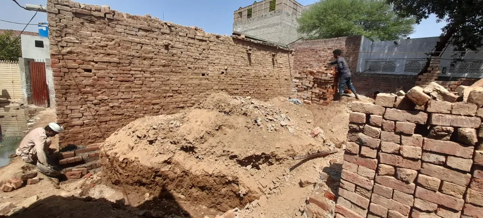 Brick walls and earthworks at a house construction site