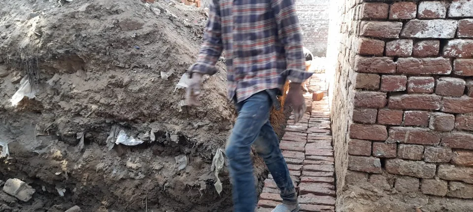 Excavated trench between brick walls