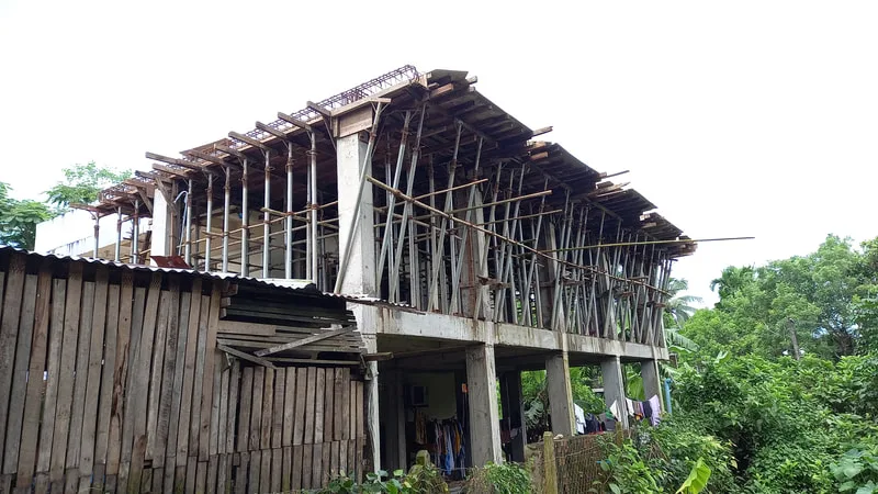 Upper floor under construction with bamboo scaffolding