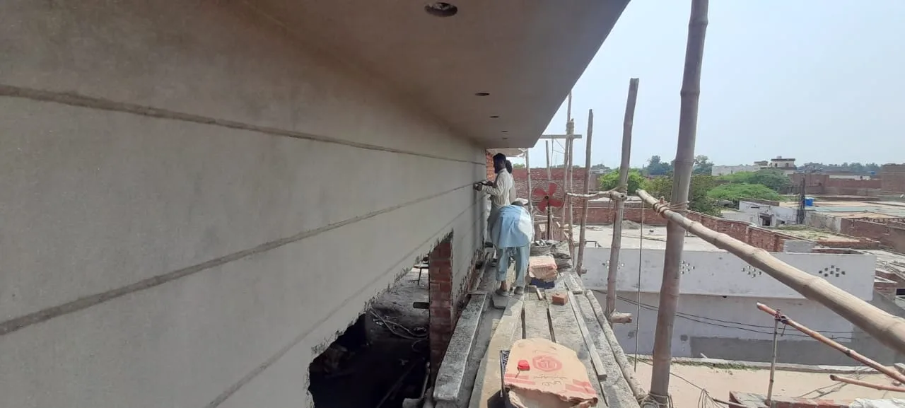 Freshly plastered facade beside scaffolding