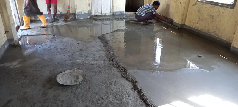 Workers finishing a newly poured floor