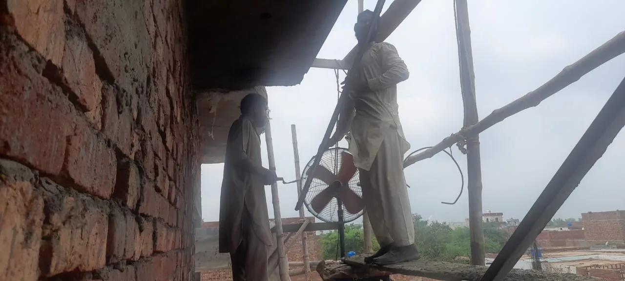 Worker plastering an exterior wall