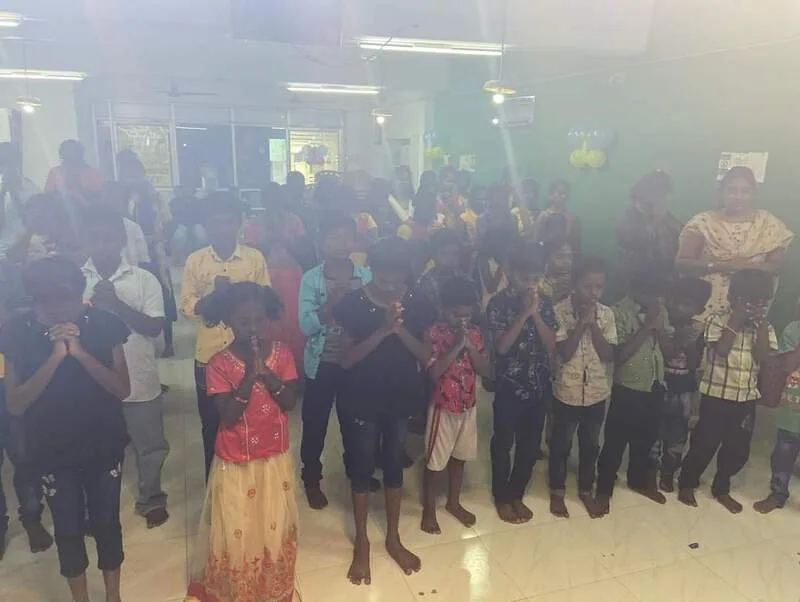 Children and adults standing together during a group activity