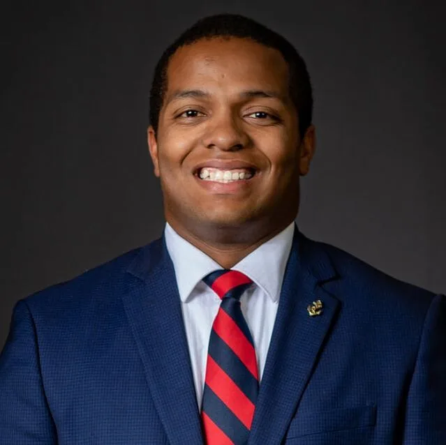 Portrait of a man in a suit and red tie
