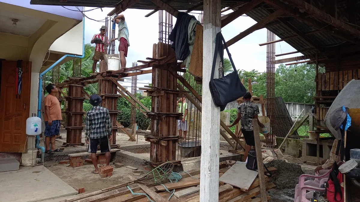 Workers installing concrete column formwork