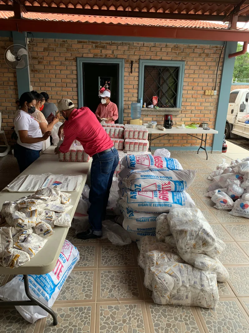 Food packages being prepared at a covered table