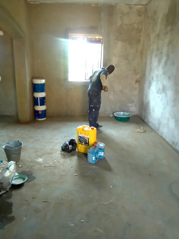 Worker finishing an interior wall