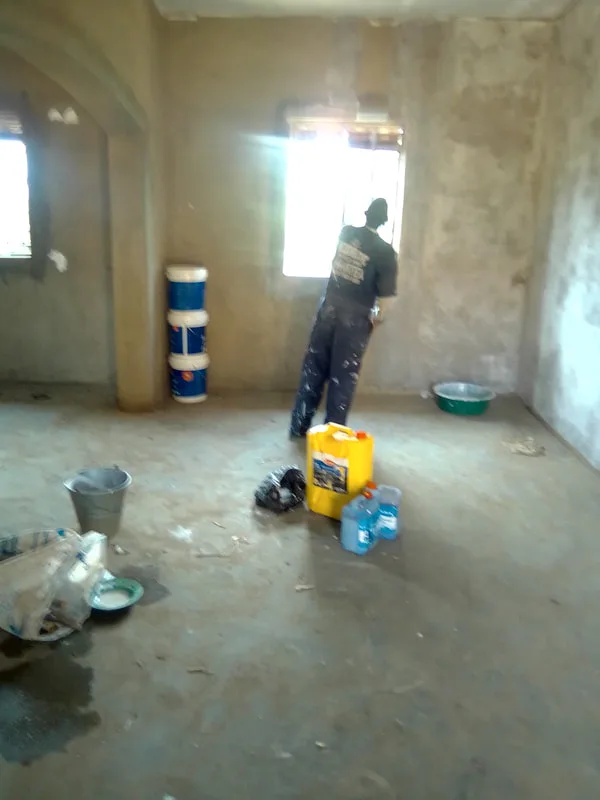 Worker plastering near a window