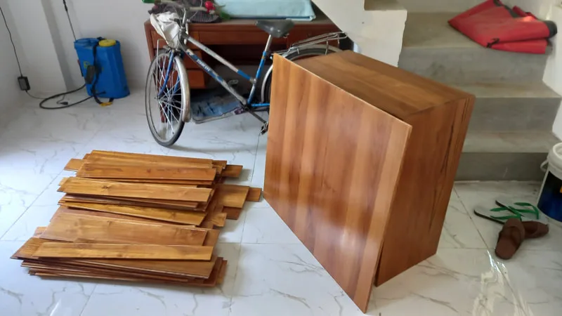 Wooden furniture parts arranged on a tiled floor