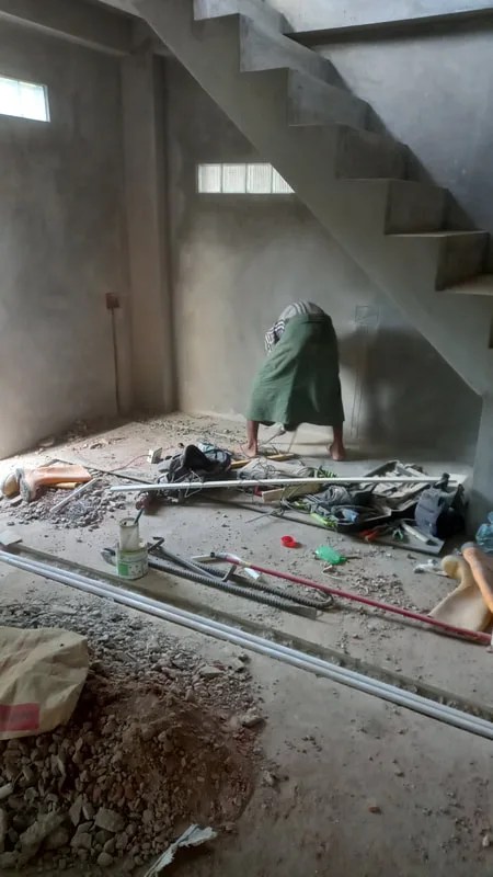 Building materials beneath an unfinished staircase