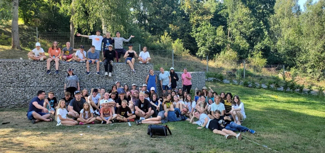 Group gathered on a grassy hillside