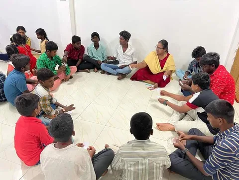 Children and adults seated in a circle with books