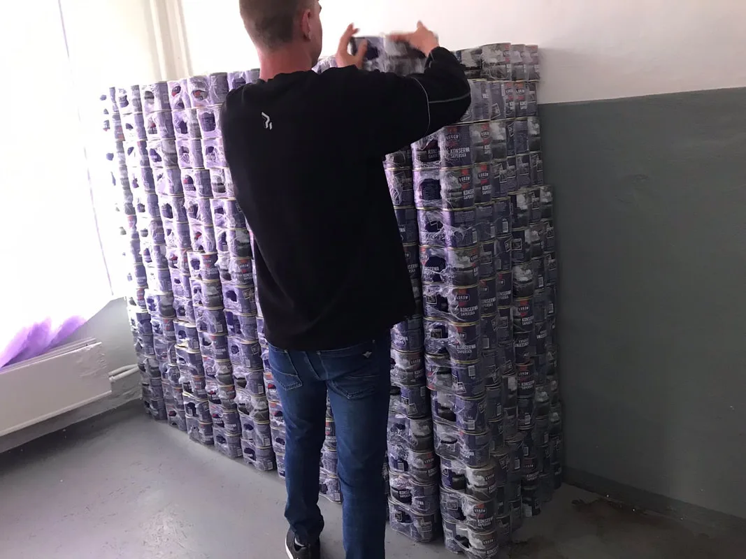 Man stacking supplies in a room