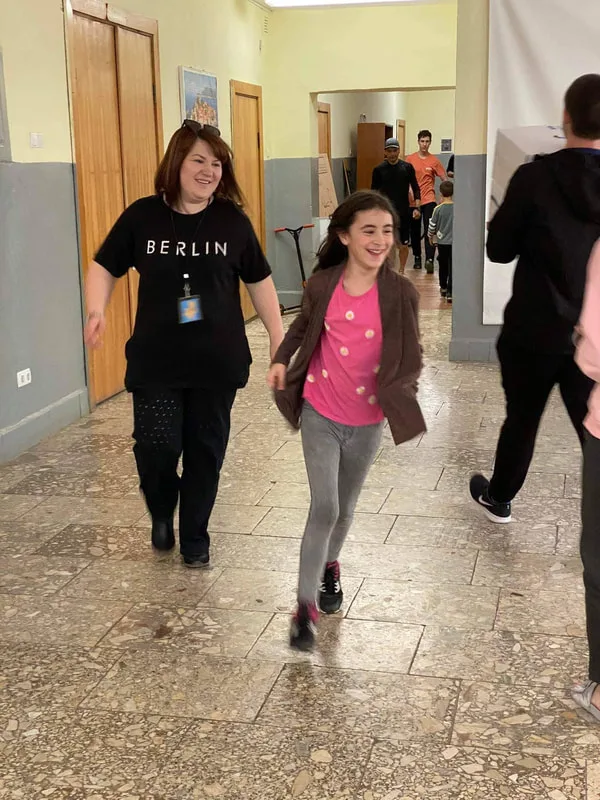 Young people walking along an indoor corridor