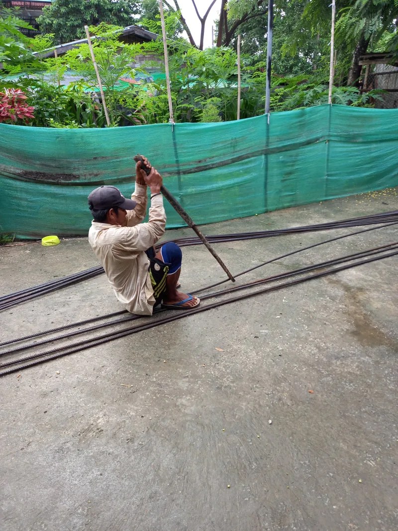 Worker preparing steel reinforcing rods