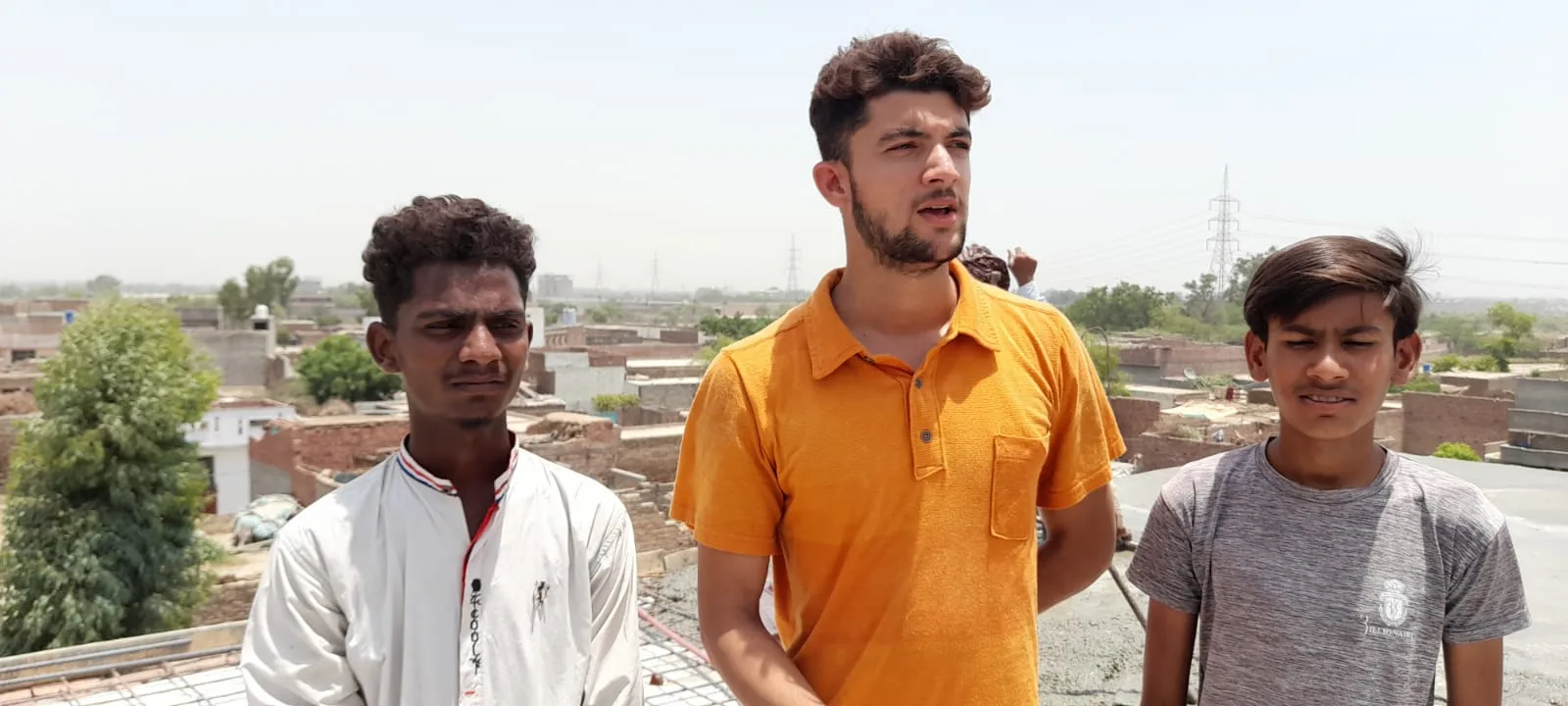 Three young men at the Pakistan Bible College construction site