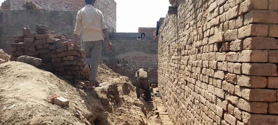 Excavated ground beside a brick wall