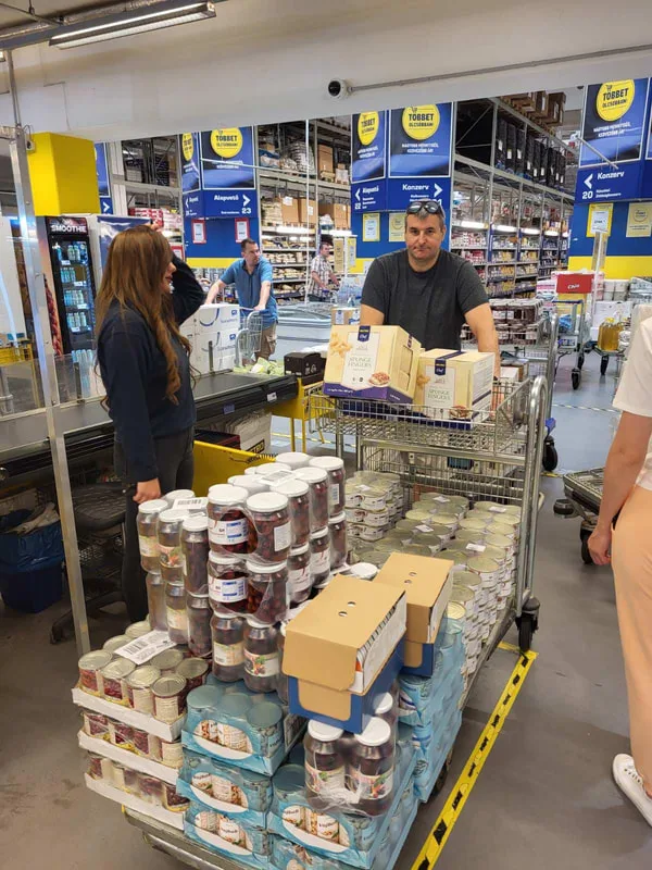Man standing beside food supplies in a shop