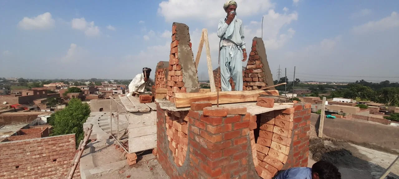 Workers building a decorative rooftop feature