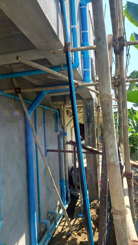 Blue plumbing pipes outside a building
